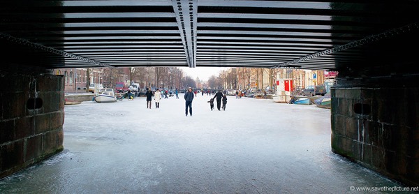 Amsterdam frozen canals bridge